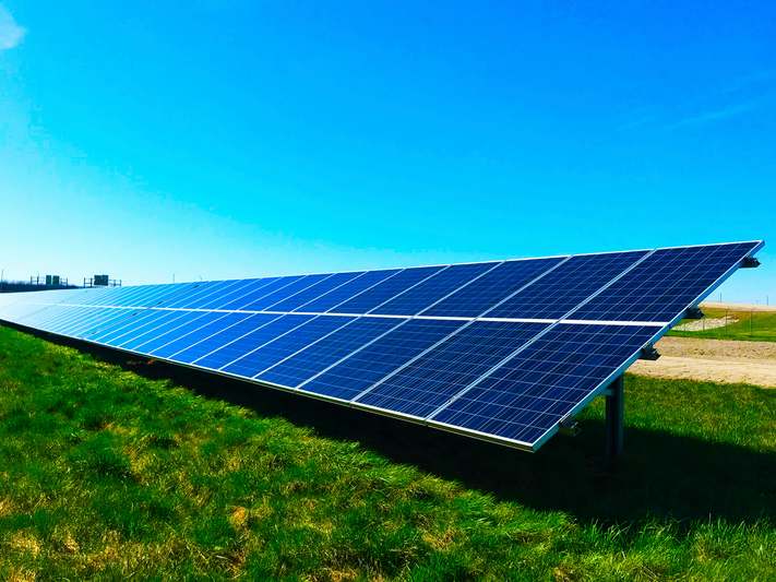 Hands installing an MPPT charge controller in a solar power system